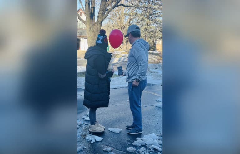 Parents releasing a red balloon