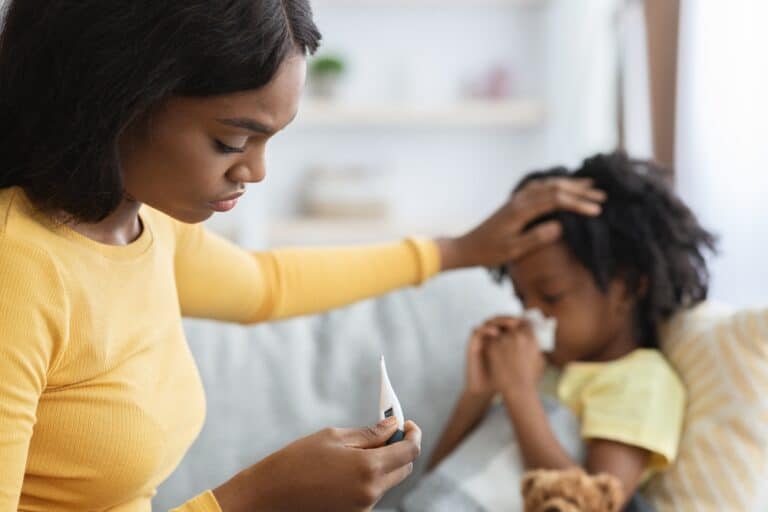Mom checking child's temperature