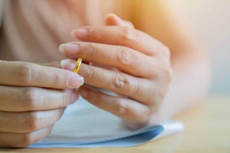 Woman taking off wedding ring