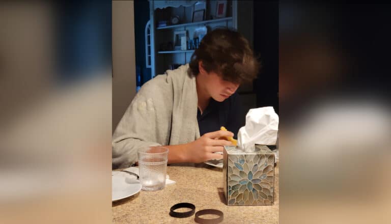 Ten boy eating breakfast at kitchen counter