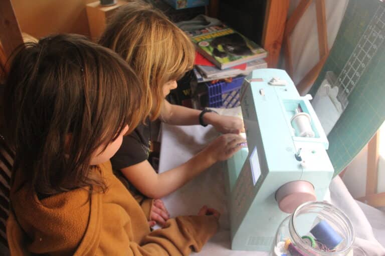 Children sewing at machine