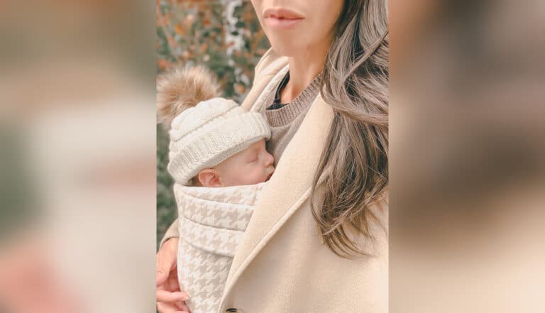 Mother with baby strapped to chest