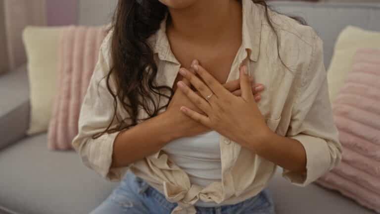 Woman with hands over heart