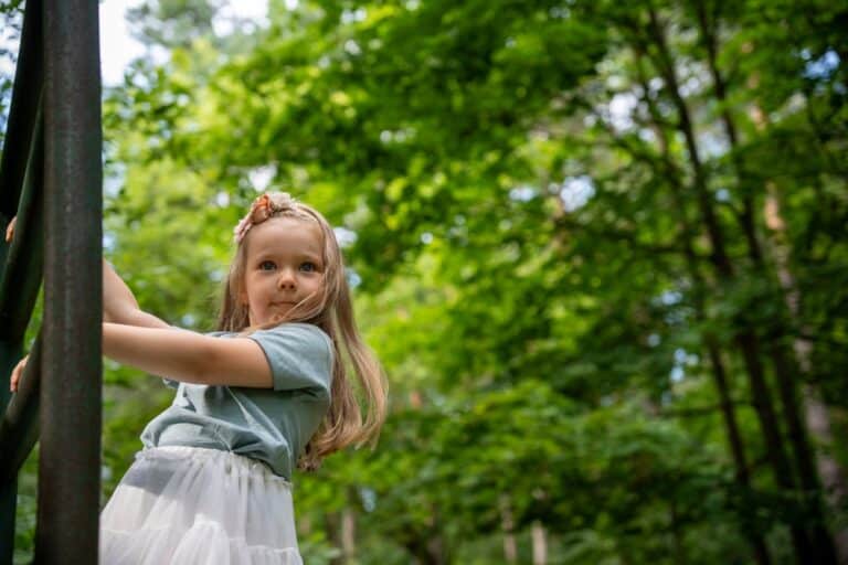 Little girl climbing outside