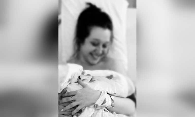 Mother holding newborn baby, black and white image