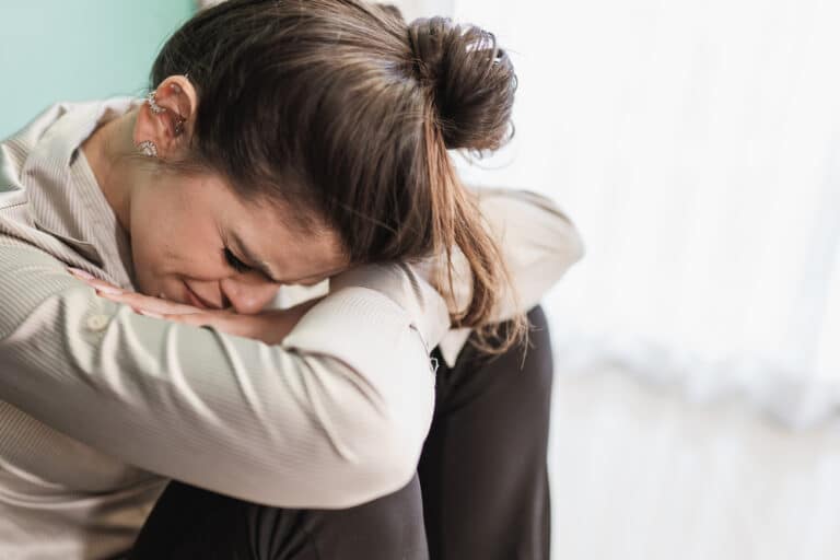Woman worried with head in lap