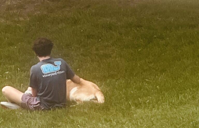 Teen sitting with dog