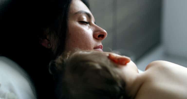 Mother holding sleeping child