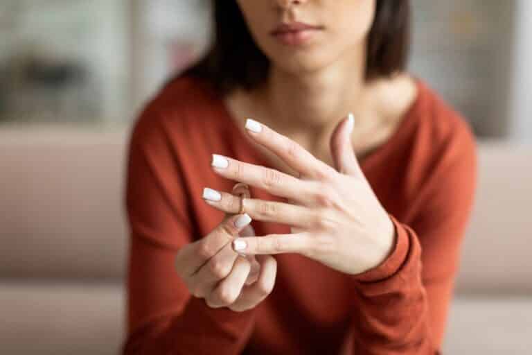 Woman taking off wedding ring